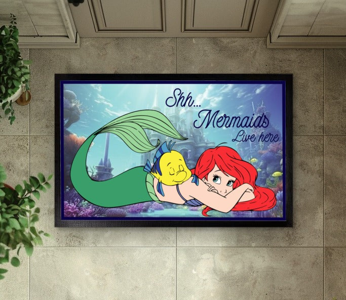 Enchant your entryway with this magical Mermaids Welcome mat.