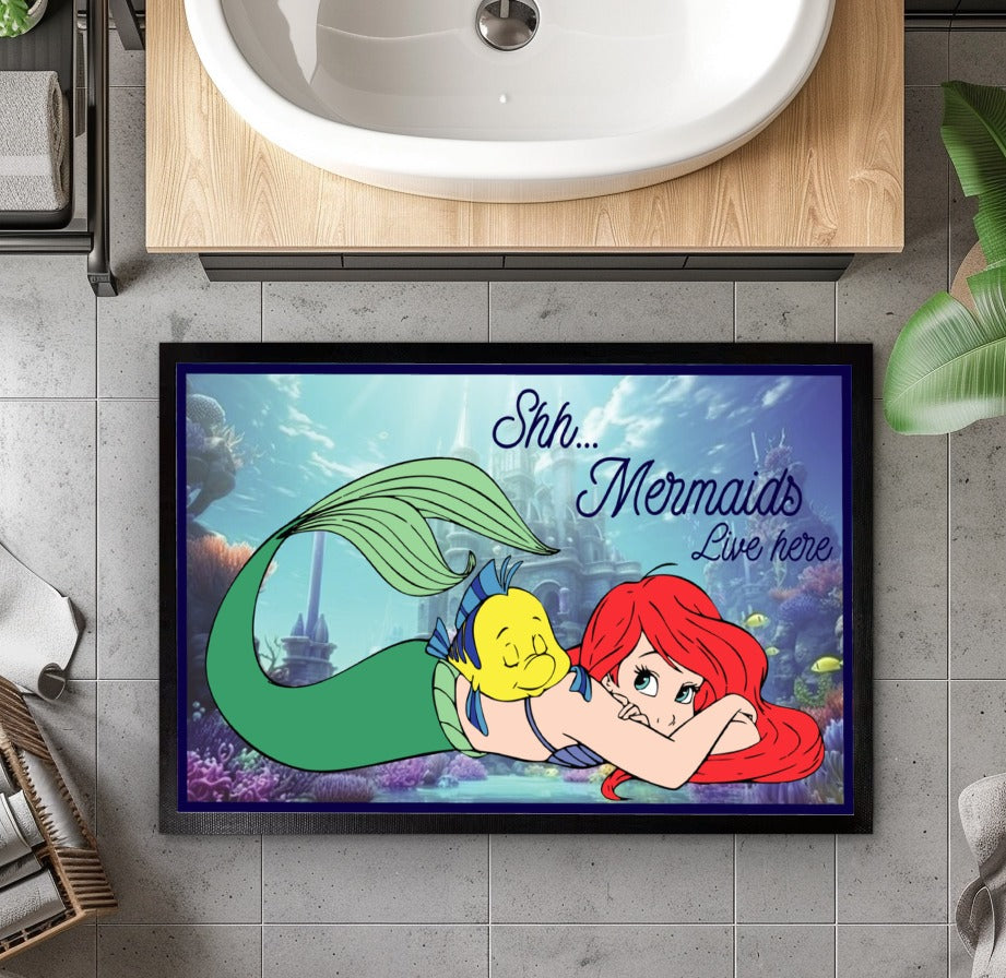 Enchant your entryway with this magical Mermaids Welcome mat.