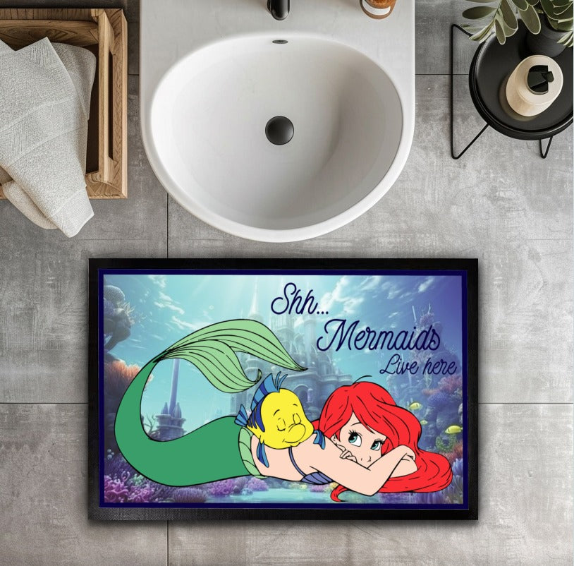 Enchant your entryway with this magical Mermaids Welcome mat.